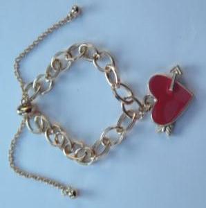 Gold bracelet with red heart charm