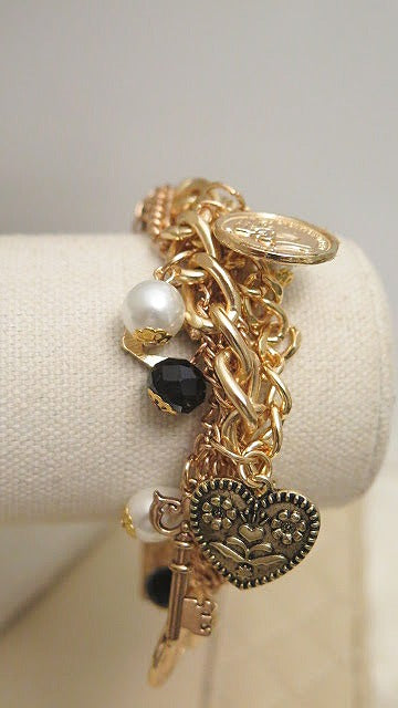 Gold chunky bracelet with charms