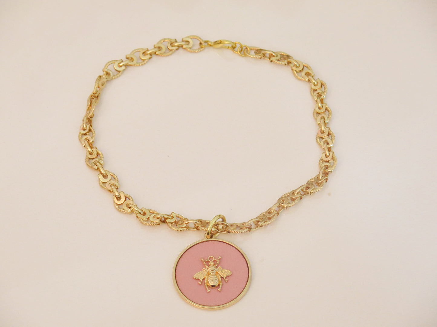 Gold necklace and pink pendant