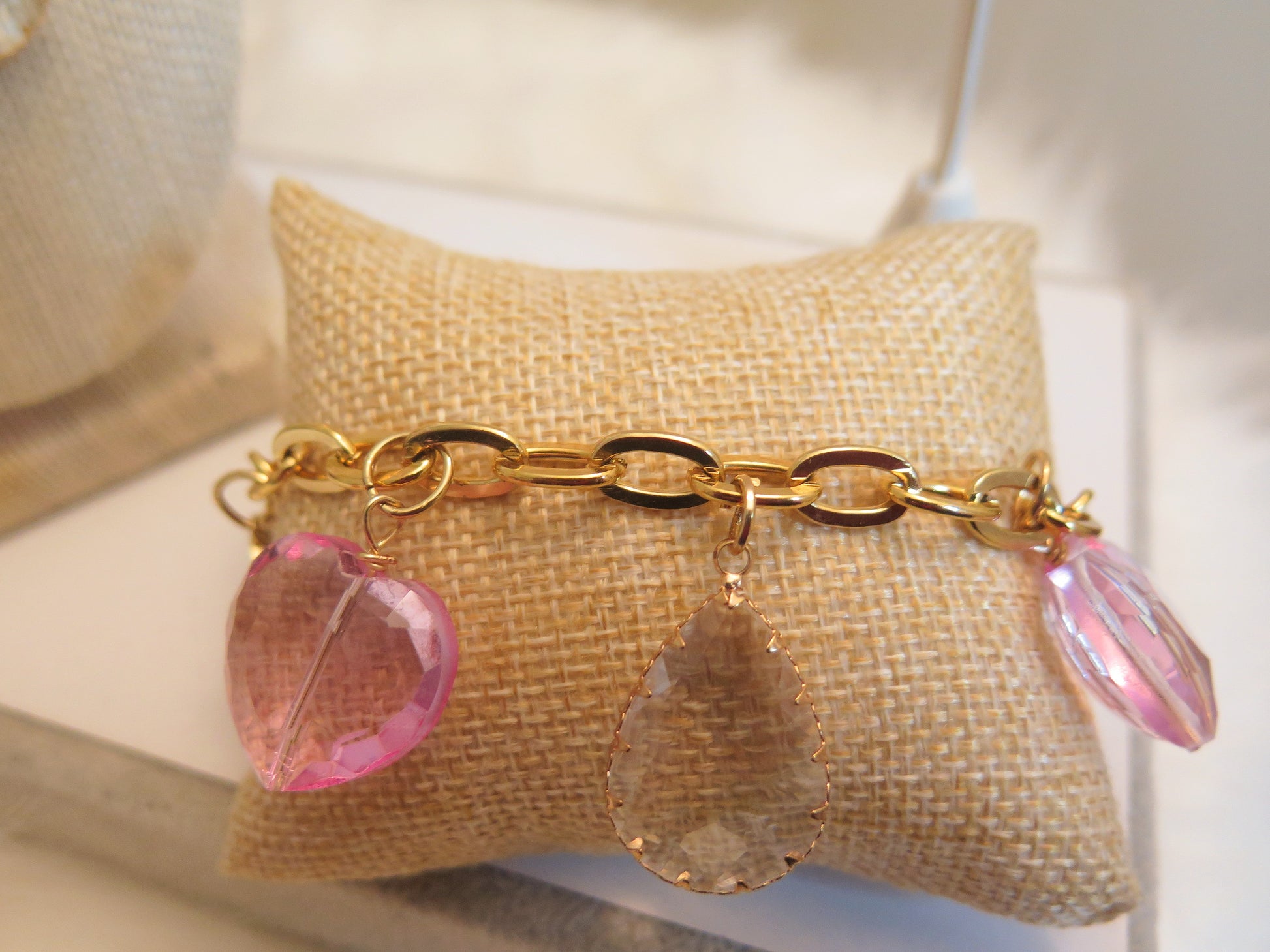gold bracelet with pink heart-shape charms