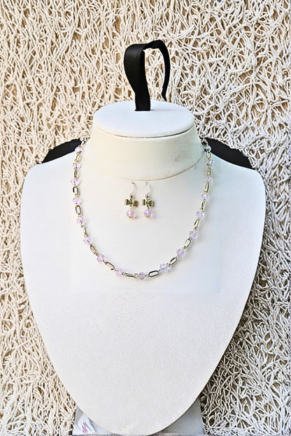 Necklace and earrings set with a textured beige background