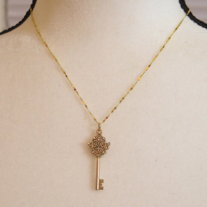 Gold necklace with key pendant