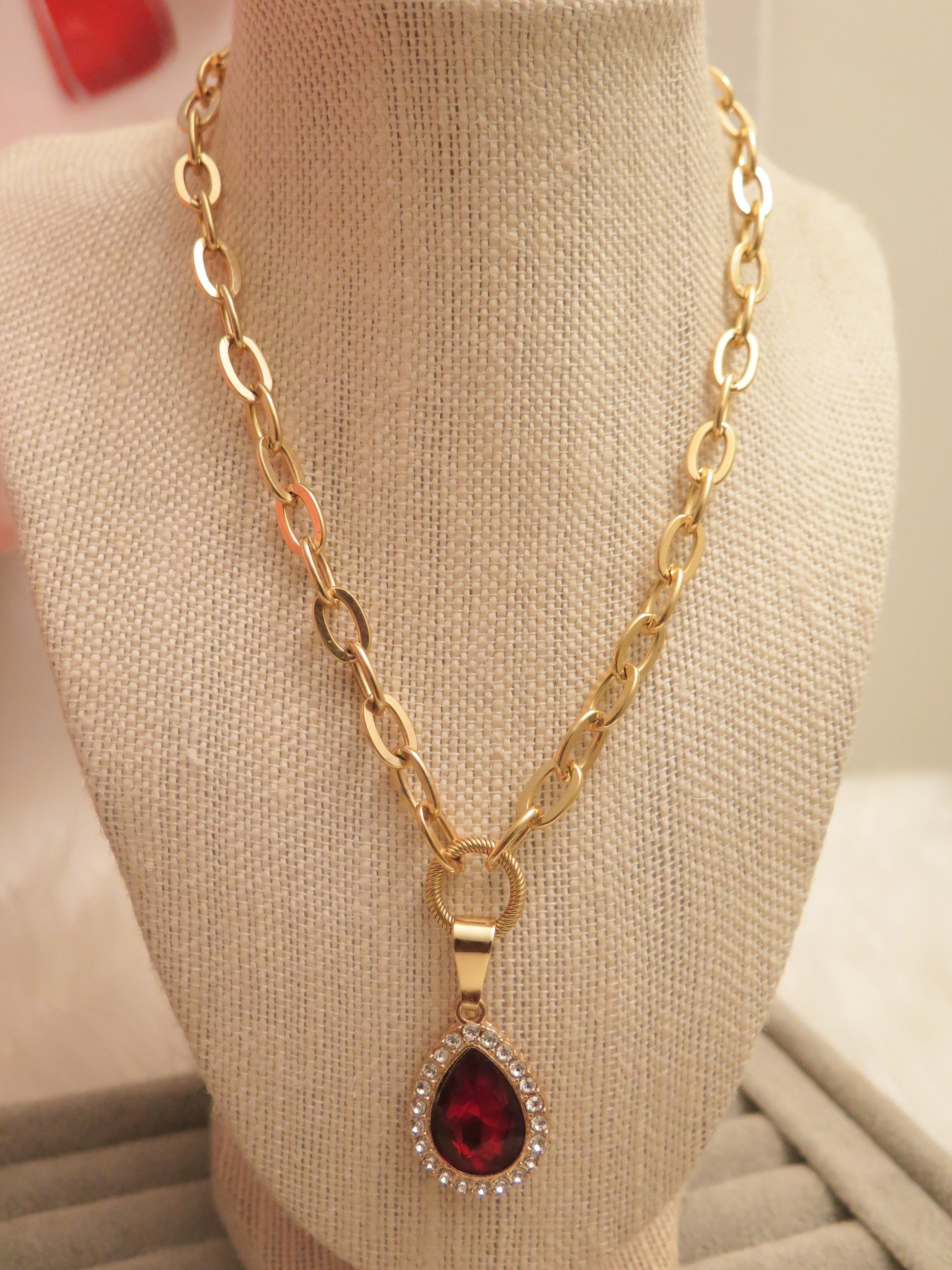 Gold necklace with red pendant