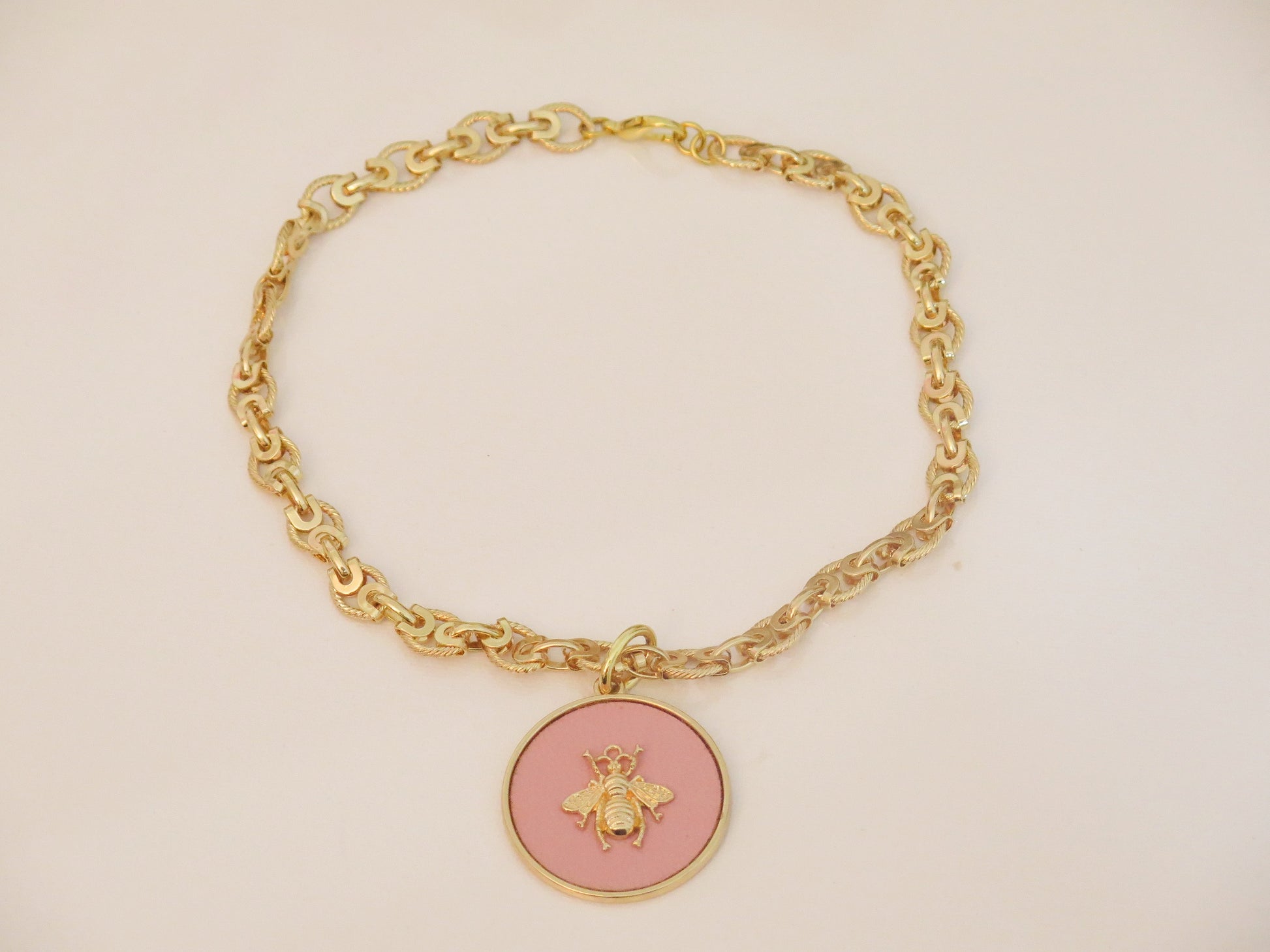 Gold necklace and  pink pendant