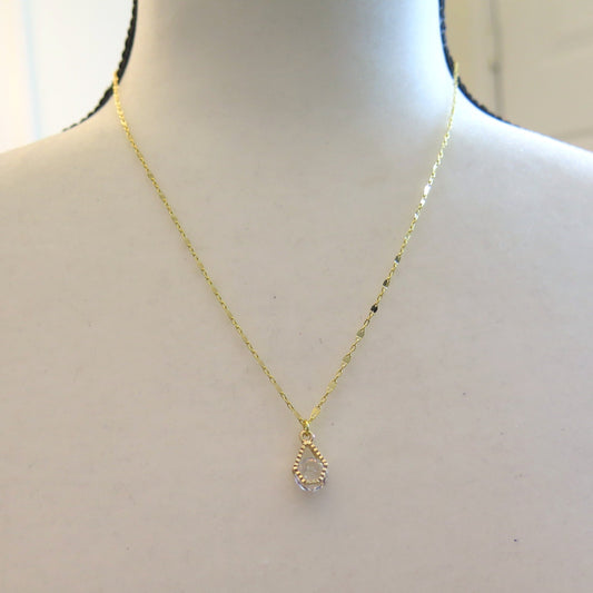 Gold necklace with clear pendant