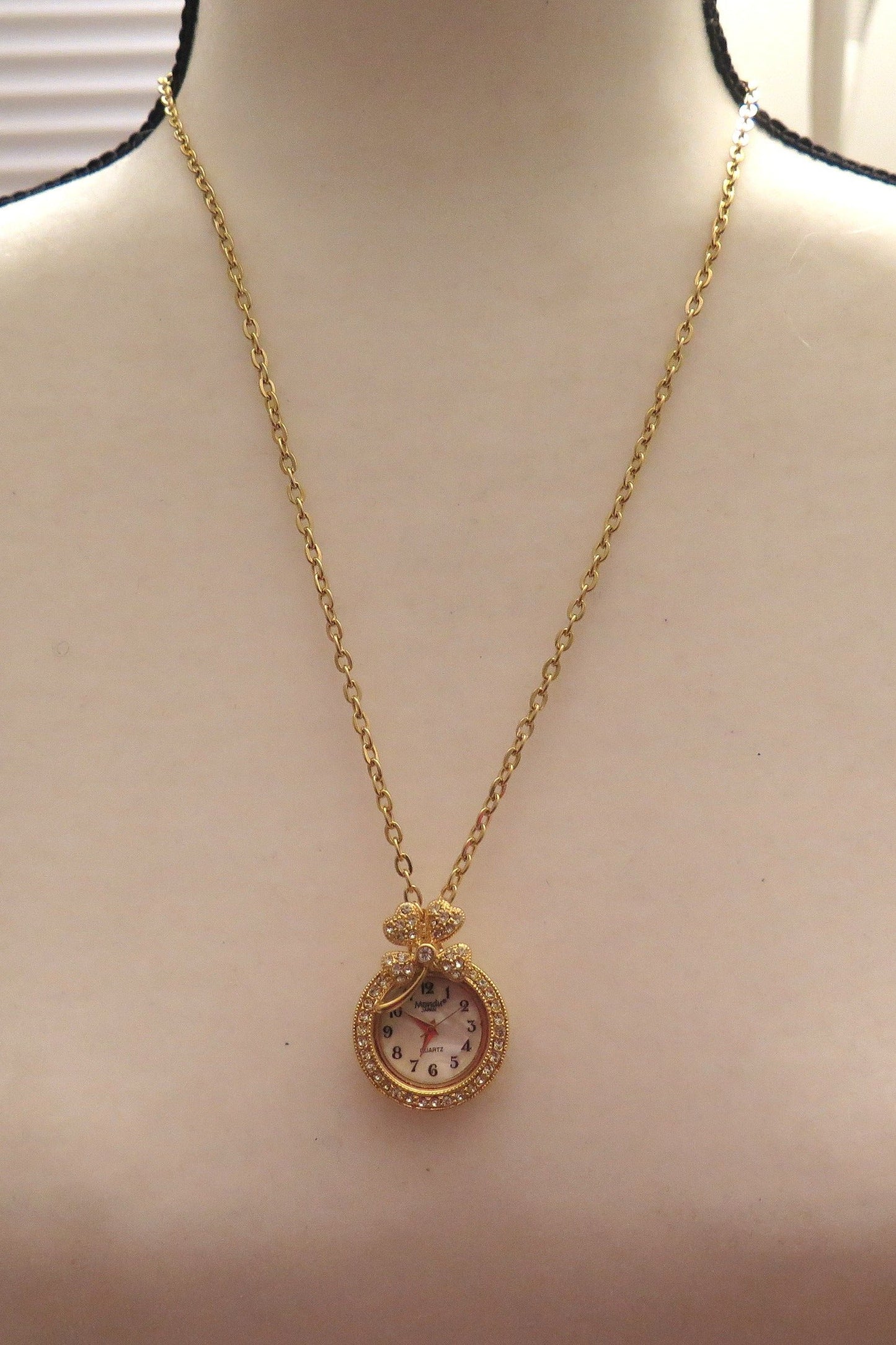 Gold necklace with clock pendant