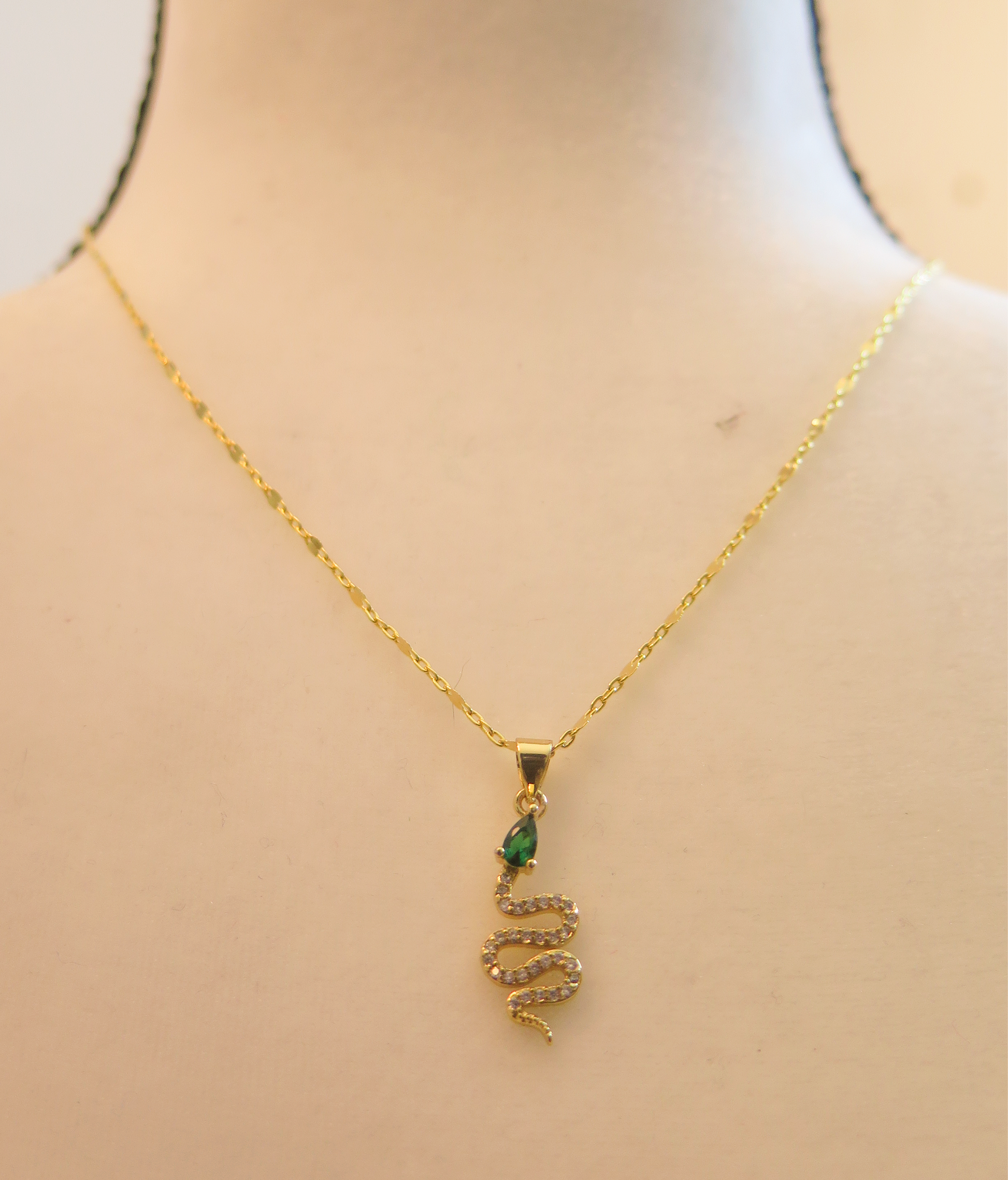 Gold necklace with green snake pendant