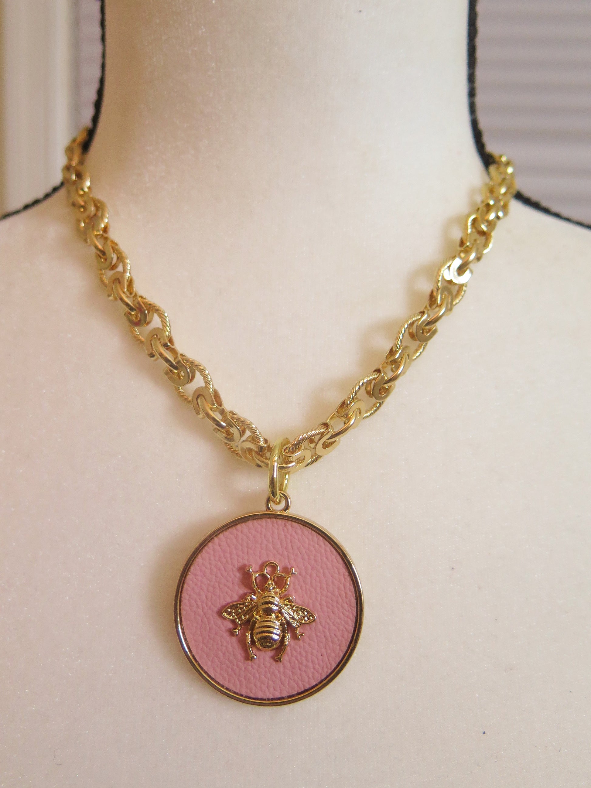 gold necklace with pink bee pendant