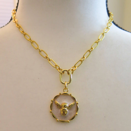 Gold necklace with white pendant