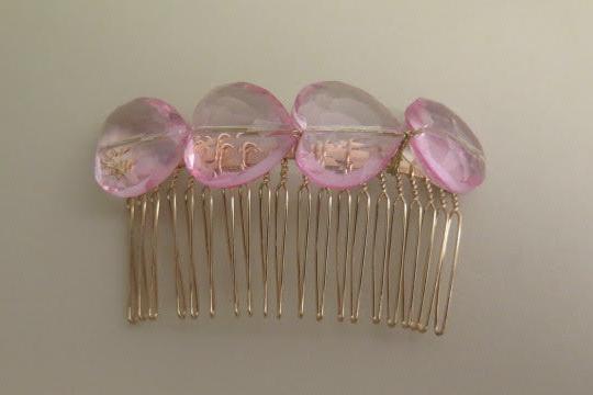 Pink heart shape beads hair comb close up detail