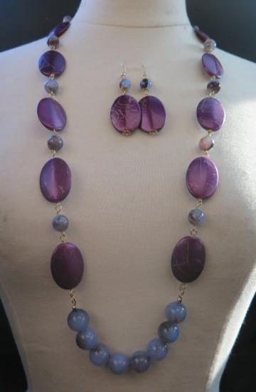 A purple set is an earring and necklace