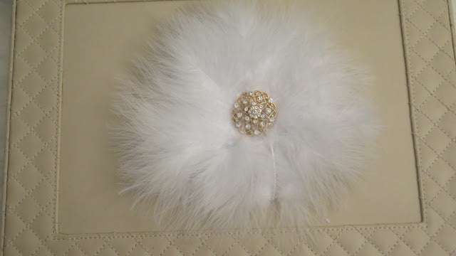 White feather brooch close up detail for wedding