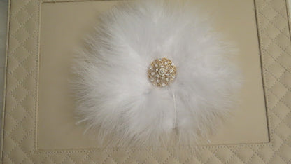 White feather brooch close up detail for wedding