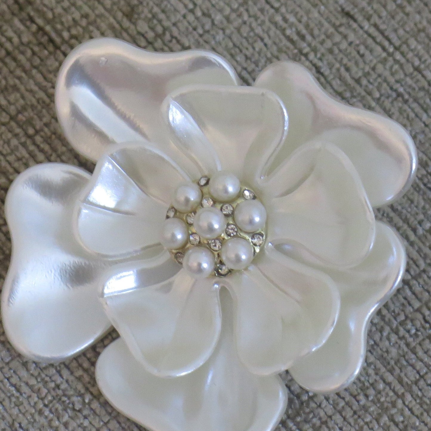 White flower brooch with pearl detail close up
