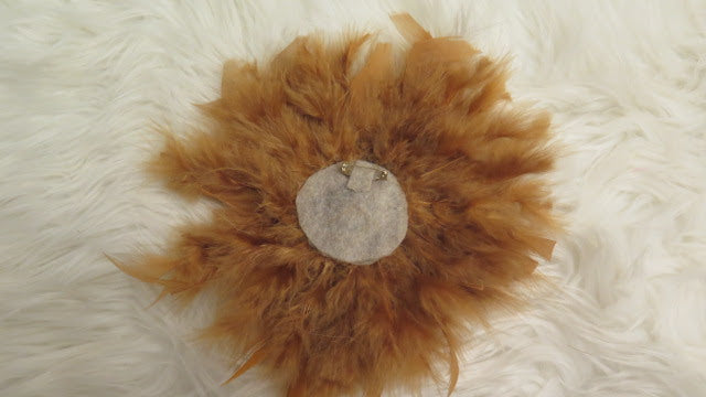 back of brown feather brooch