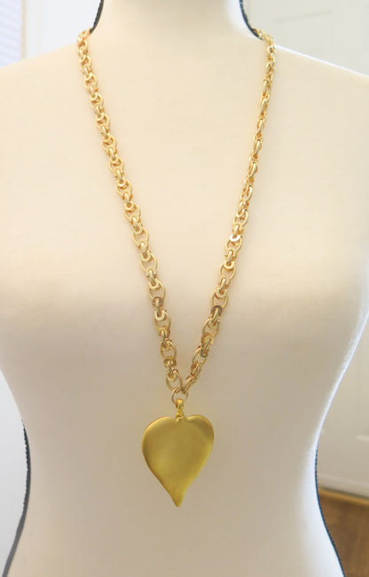 long gold necklace with leaf pendant